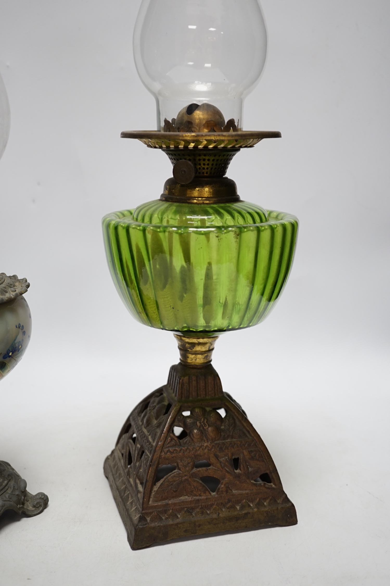Two oil lamp bases with glass reservoirs, largest 48cm high